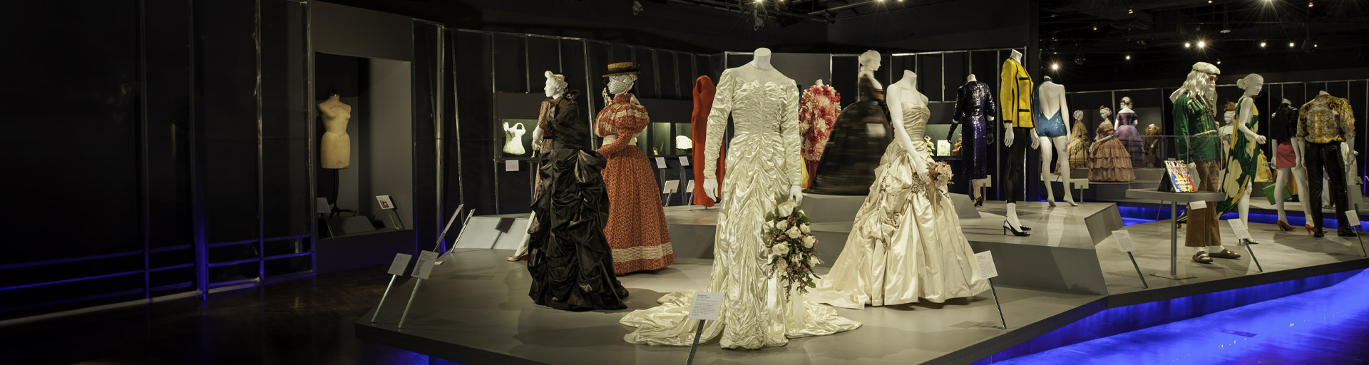 dresses on display on a light up platform