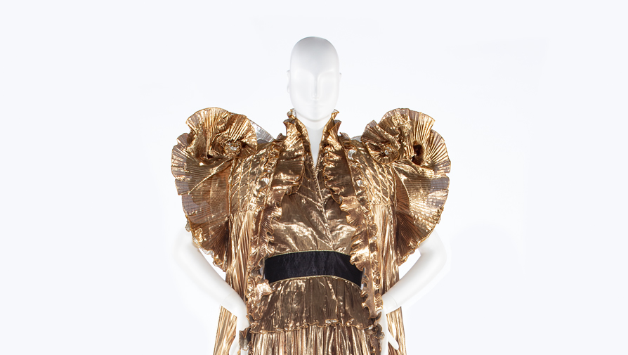 mannequin with a gold pleated dress