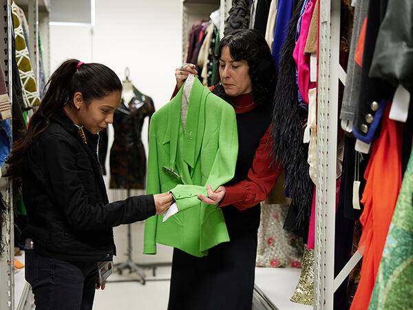 Museum visitors looking at a fashion piece